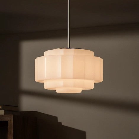 The dramatic light and shadow effect of a tiered opal glass pendant.
