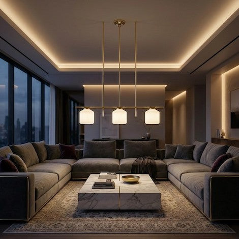 A luxurious living room featuring a large polished brass dome pendant light as a central visual statement.