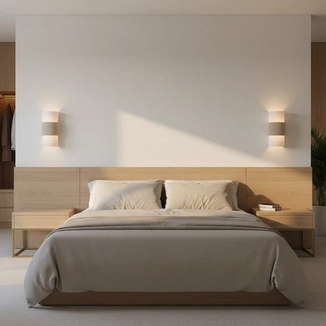 Minimalist bedroom with warm linen wall lighting.