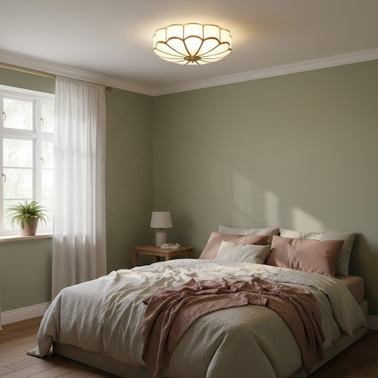 Vintage floral glass ceiling light installed in a cozy bedroom with low ceilings.