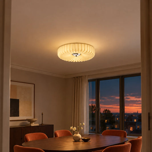 Maelis beige scalloped glass ceiling light glowing over a warm dusk dining room