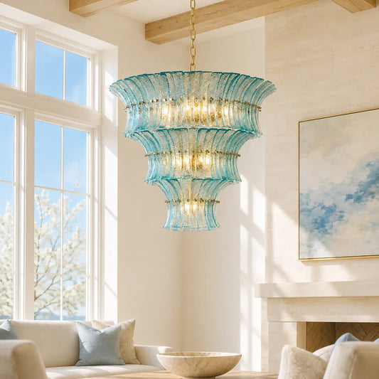 Aqua textured glass tiered chandelier in a bright high-ceiling living room