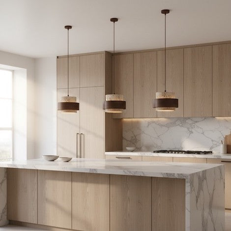 Three Aksel vintage travertine pendant lights hanging in a row over a modern kitchen island.