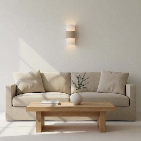 Balanced minimalist living room with textured lighting fixture.