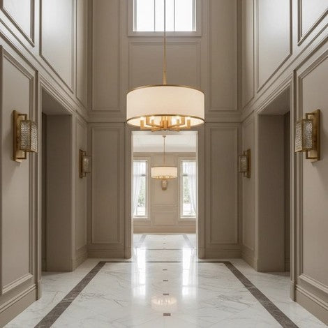 An elegant drum chandelier acting as the visual focal point in a high-ceiling entryway.