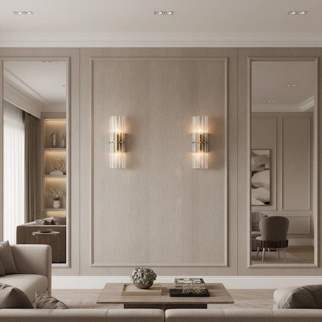Symmetrical luxury ribbed crystal double sconces on a living room wall creating a warm glow.