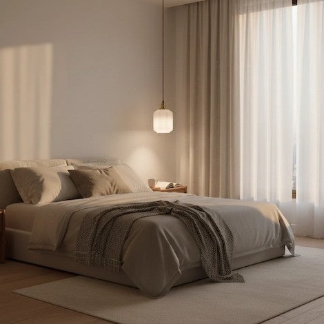 A modern bedroom featuring a creative glass lantern pendant light and warm decor.