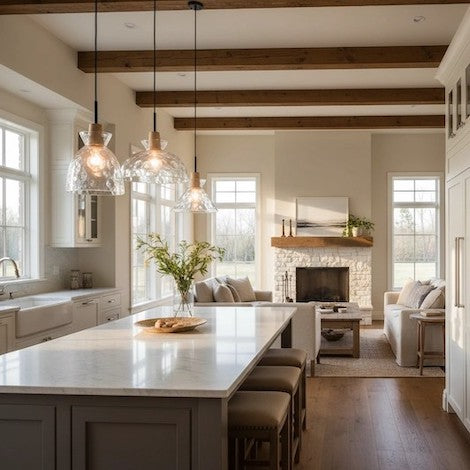 A beautifully lit modern farmhouse open-plan interior featuring hammered glass pendant lights over a kitchen island.