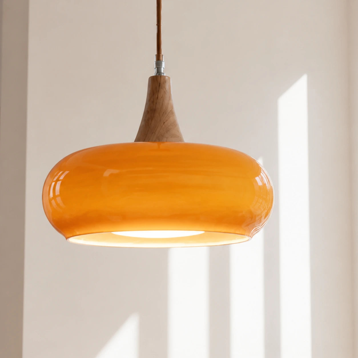 Orange Marie dome glass pendant in a bright sunlit interior