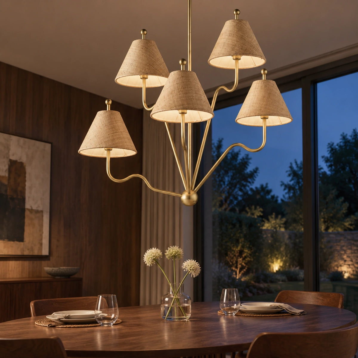 Isolde brass and raffia chandelier in a twilight dining room