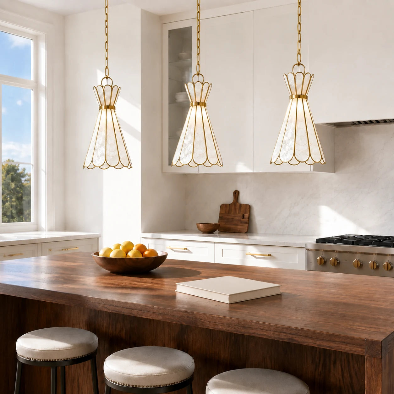 Three Mira Capiz shell pendant lights above a bright walnut kitchen island
