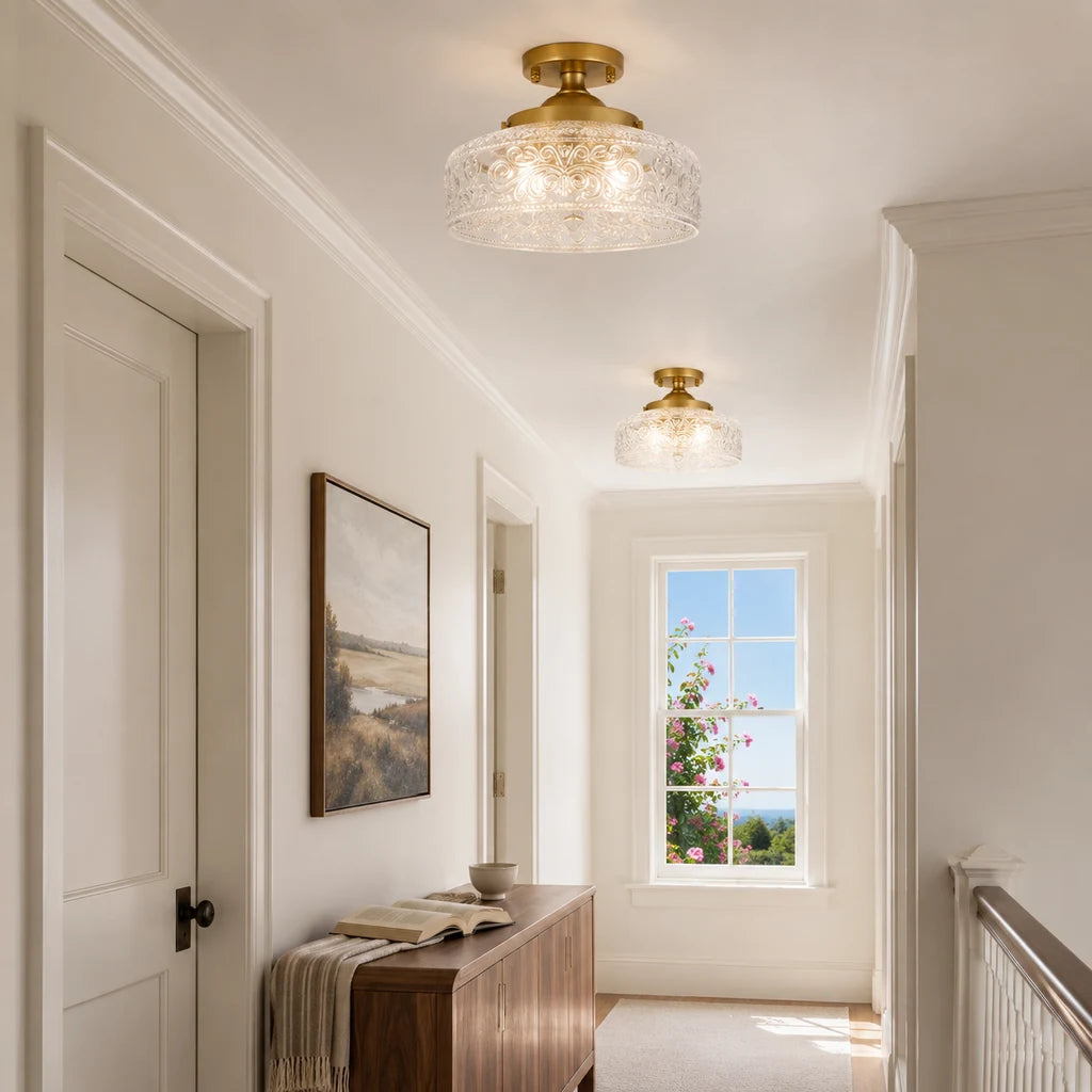 Pair of gold etched clear glass ceiling lights in a sunlit upstairs gallery