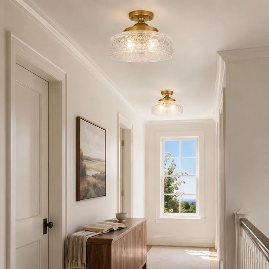 Pair of gold etched clear glass ceiling lights in a sunlit upstairs gallery
