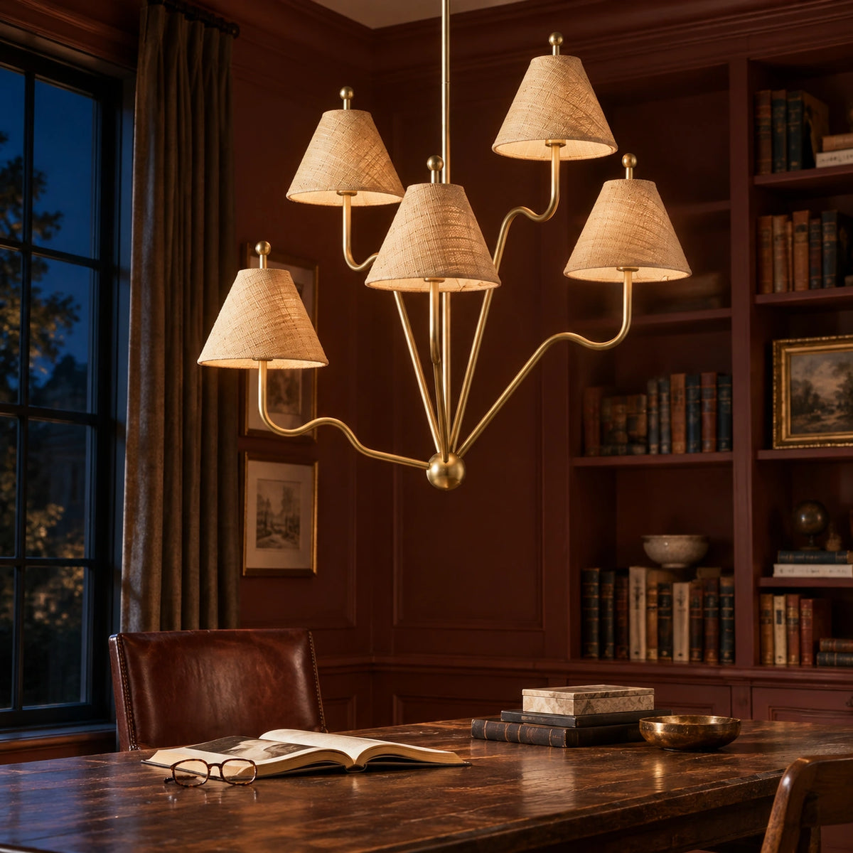 Isolde brass chandelier glowing in a dark evening library