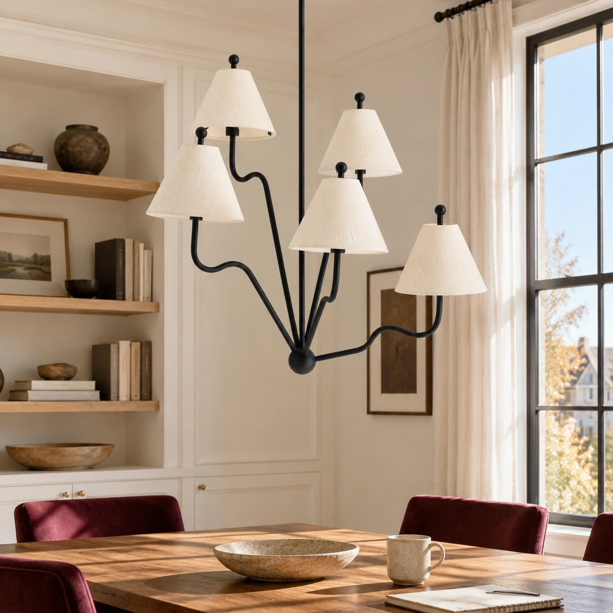 Isolde black iron five arm chandelier in a bright interior