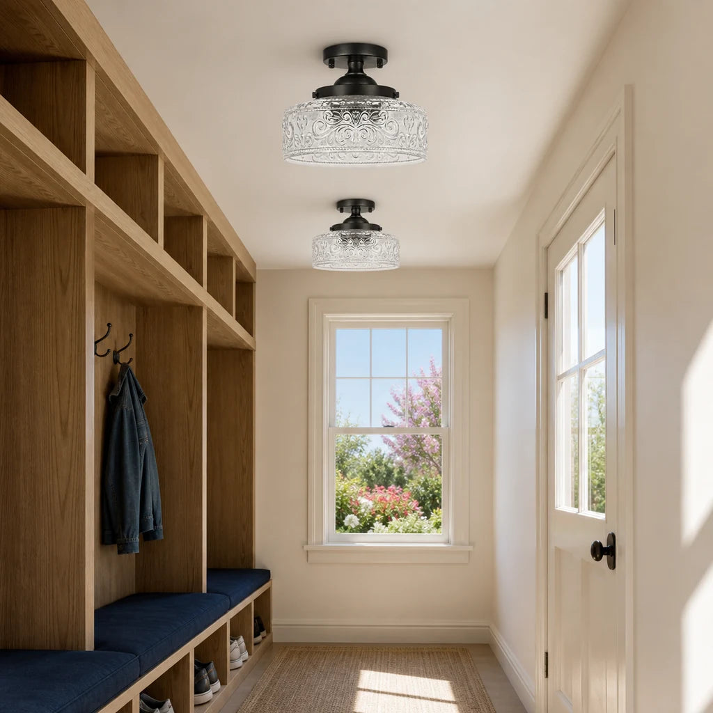 Pair of matte black etched clear glass ceiling lights in a bright mudroom