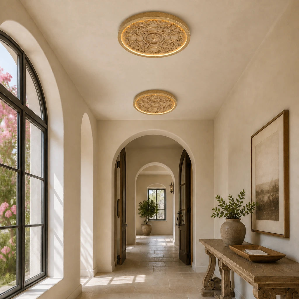 Two wood grain medallion ceiling lights in an arched entry gallery