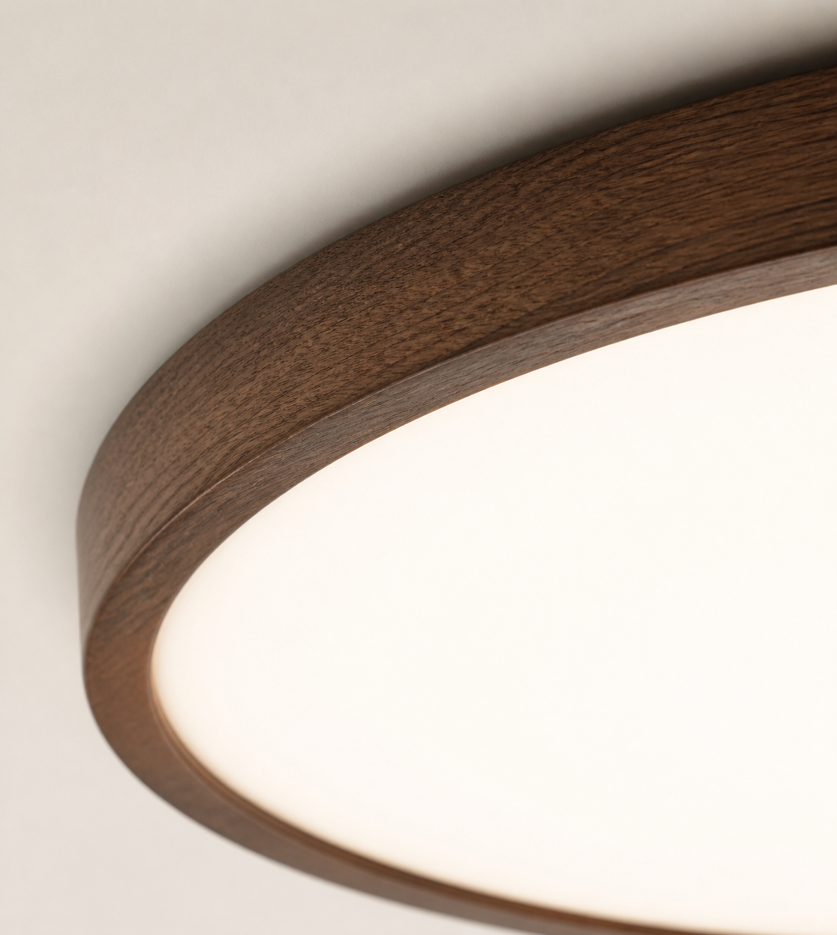 Macro detail of the deep walnut wood-grain Solenne ceiling light rim