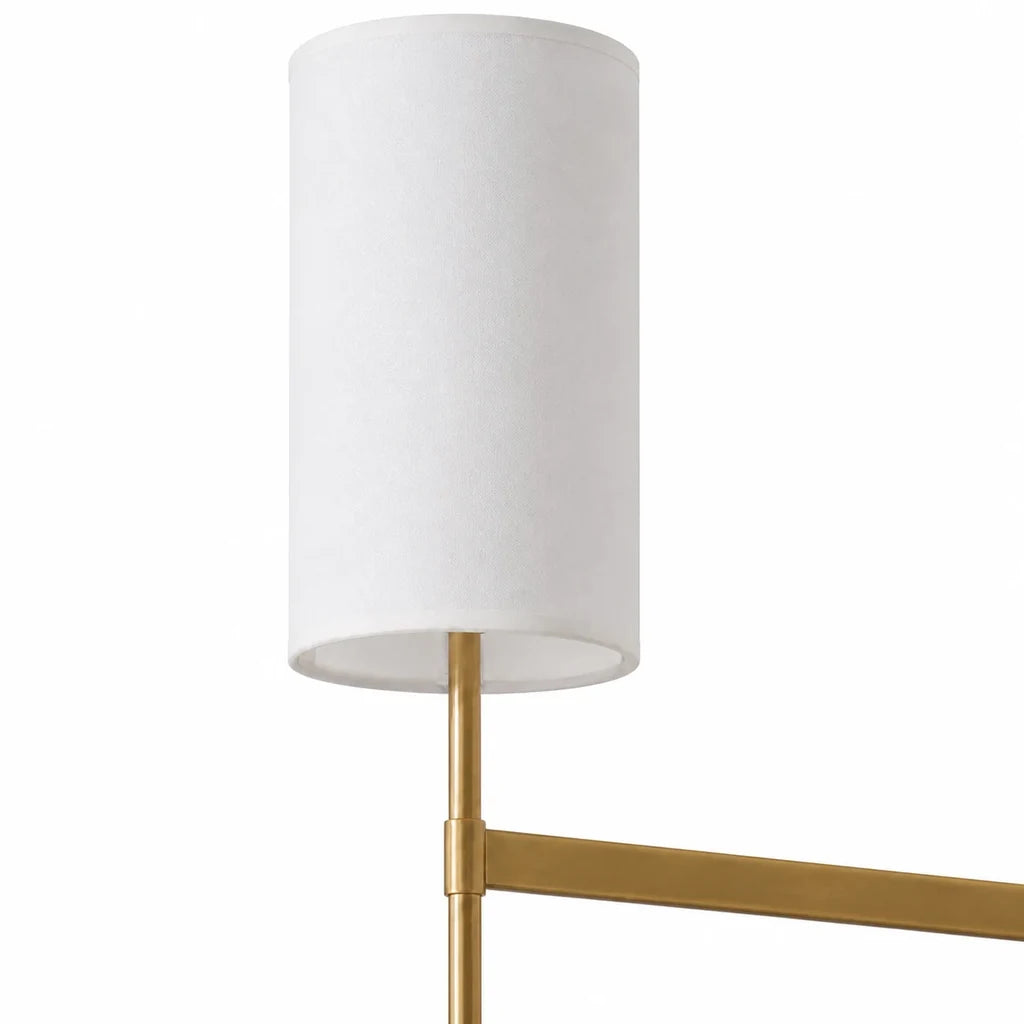 Close detail of the Aster white fabric shade and continuous brass arm