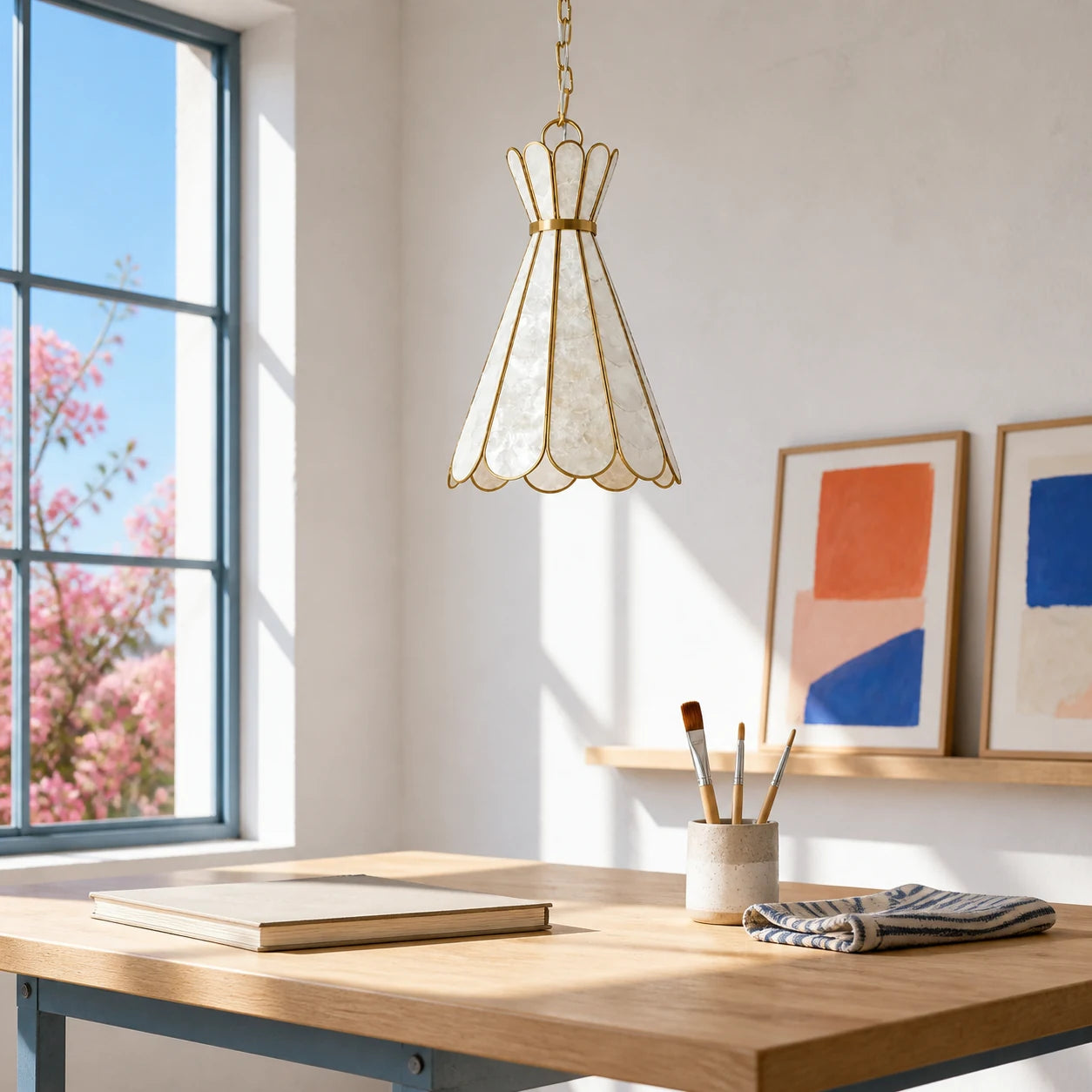 Mira Capiz shell pendant light in a sunlit art studio
