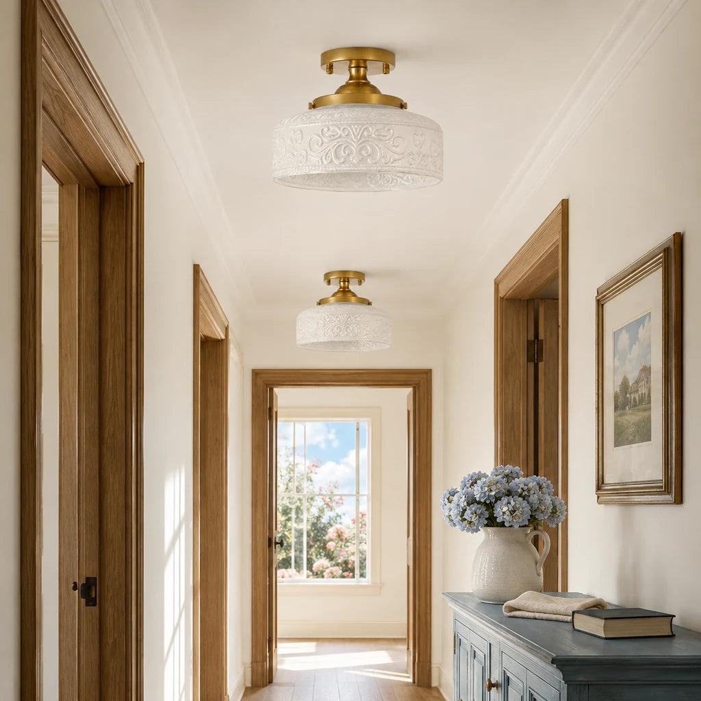 Pair of gold and white embossed glass ceiling lights in a bright upstairs hallway