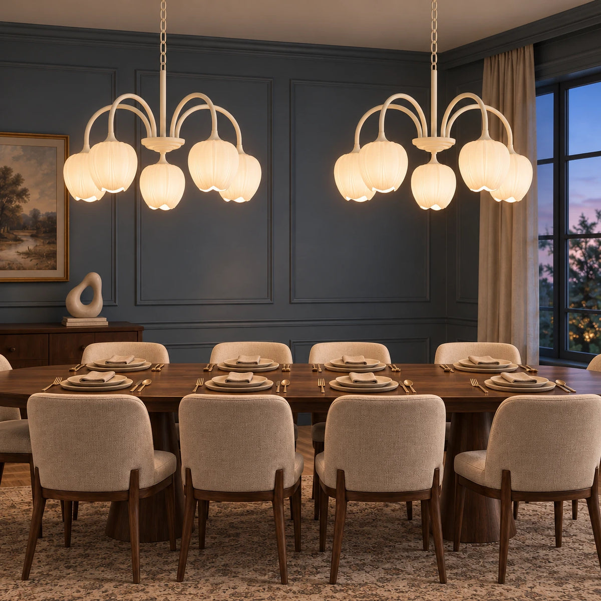Pair of five-light creamy white tulip chandeliers correctly suspended above an extended dining table with place settings