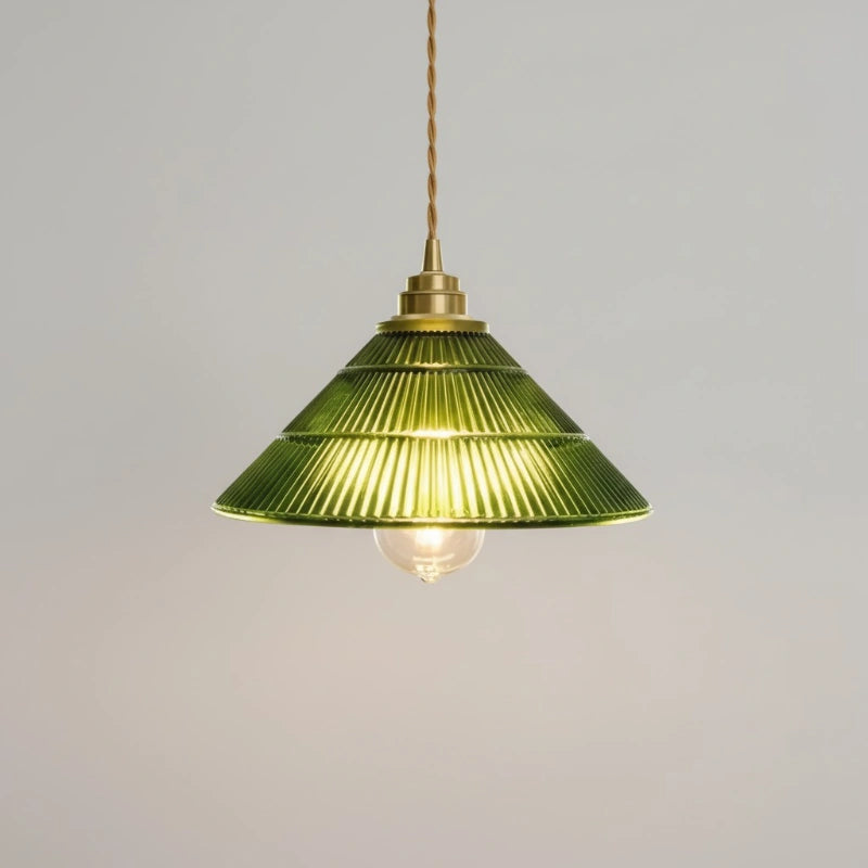 Green pendant lamp with brass fixture on a gray background
