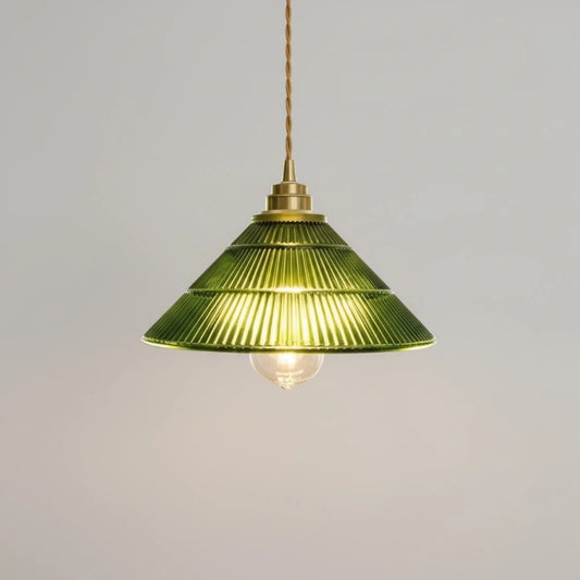 Green pendant lamp with brass fixture on a gray background