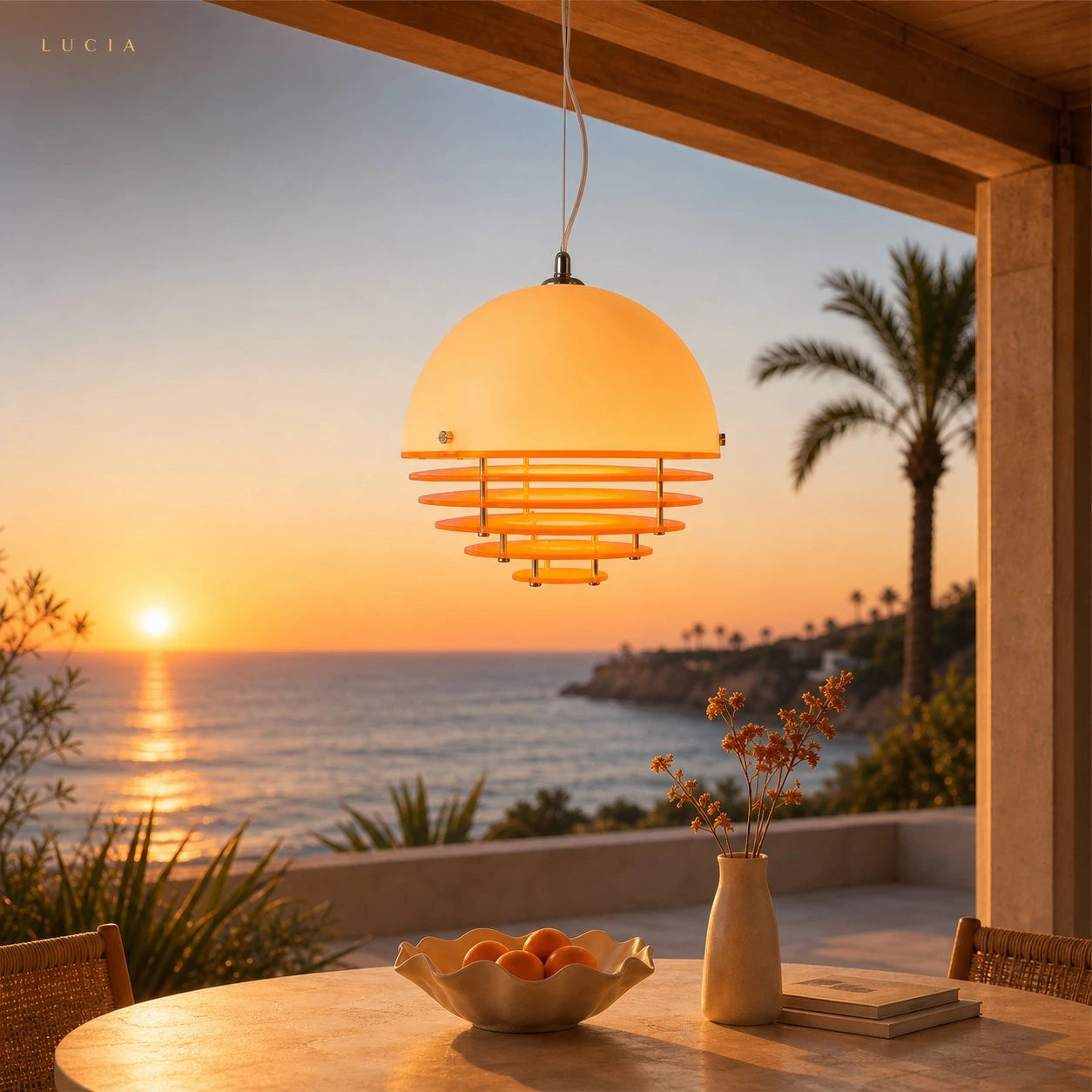 Lucia sculptural pendant glowing above a table at sunset