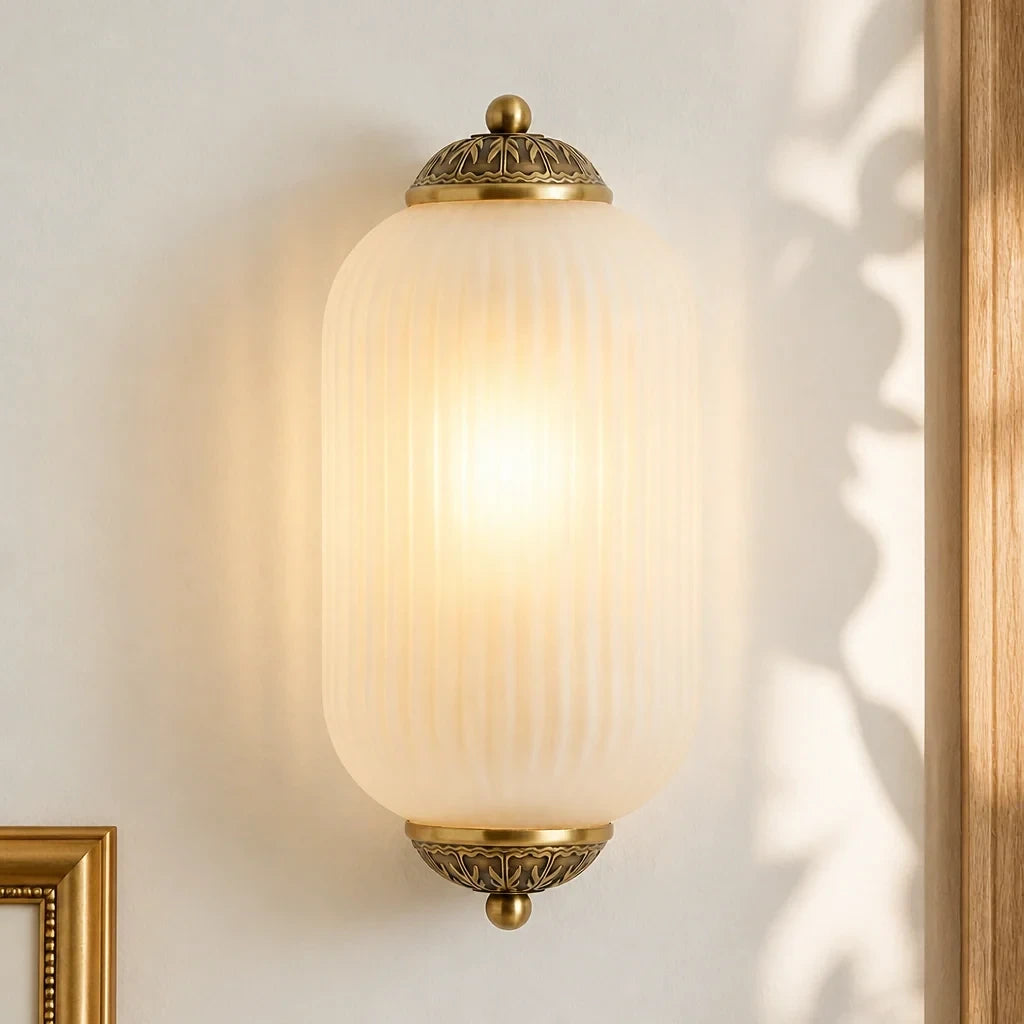 Eloise wall sconce illuminated form and antique brass finish