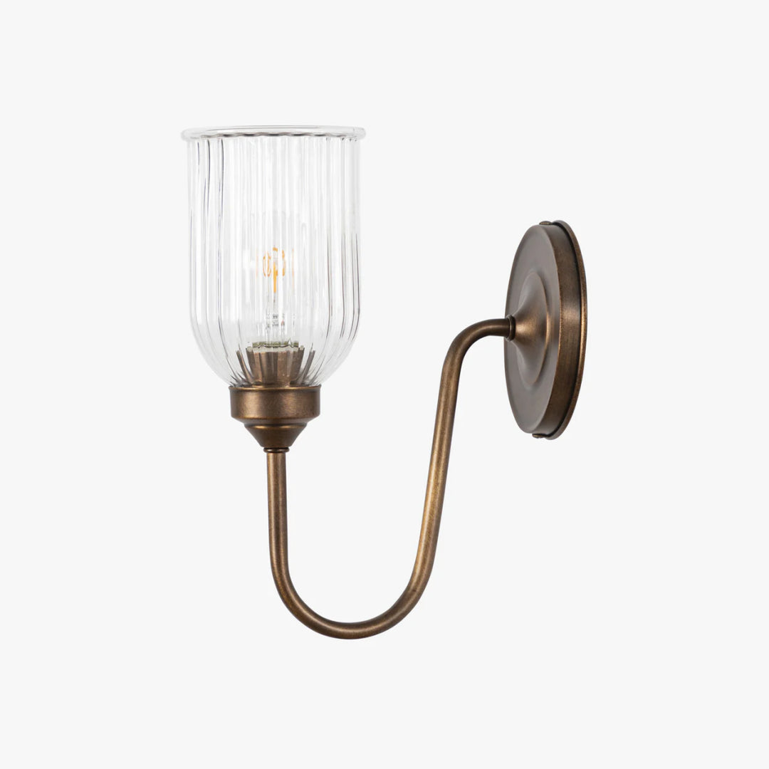 Menae wall sconce in Antique Brass on a white background