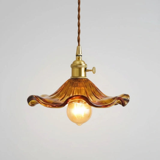 Vintage-style pendant light with wavy amber glass shade on a plain background