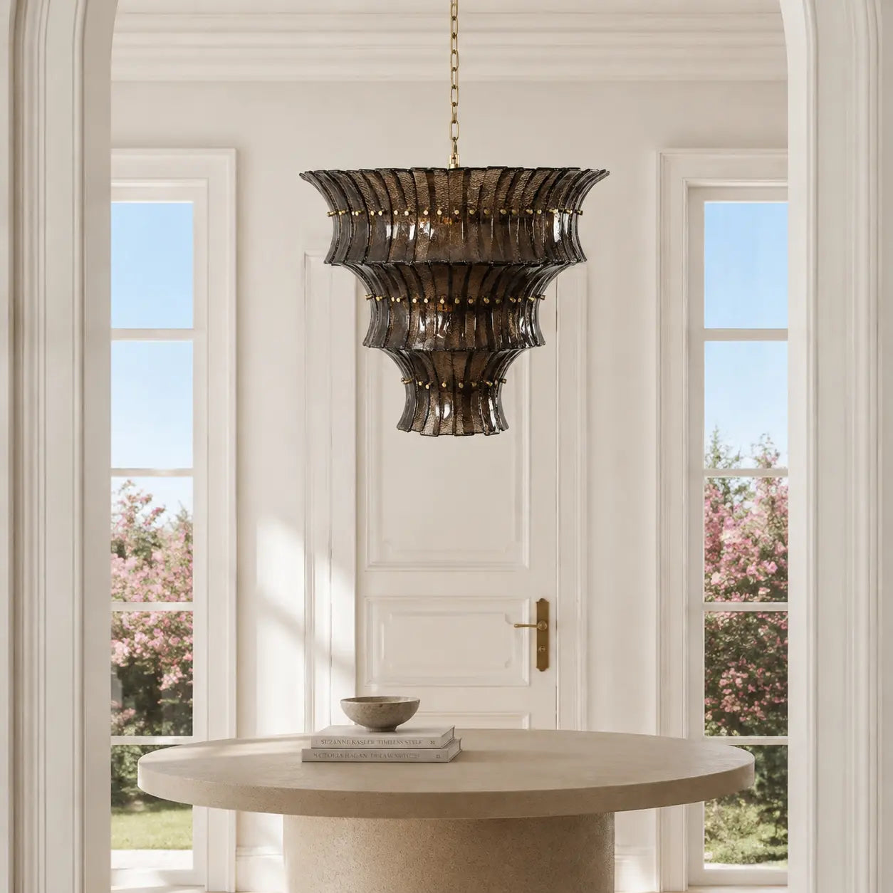 Smoked amber textured glass tiered chandelier in a bright entryway