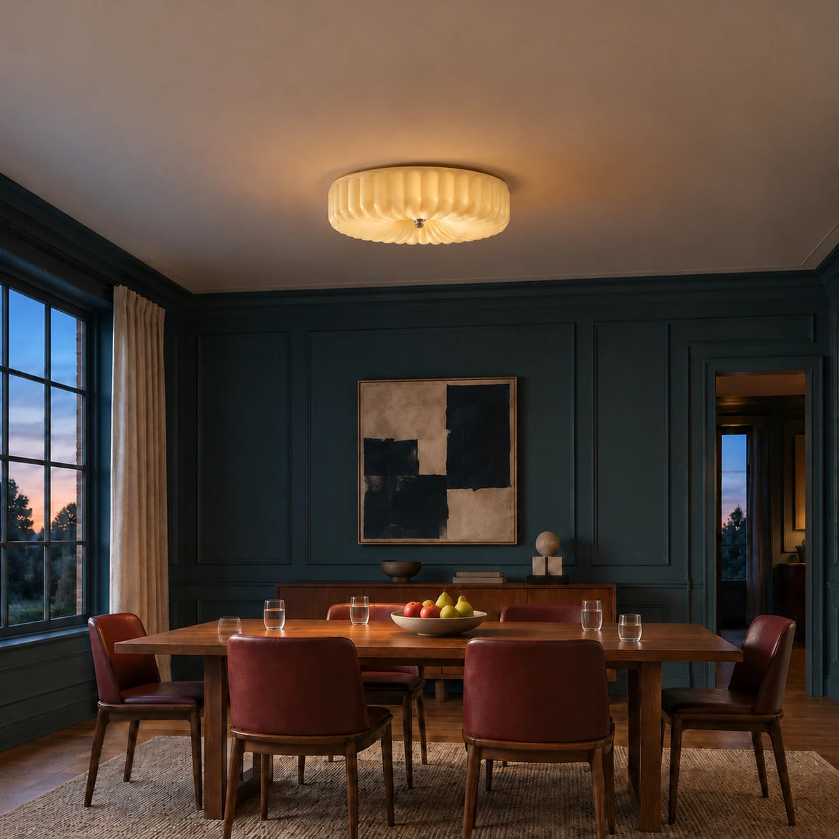 Maelis 40 cm beige scalloped glass ceiling light glowing over an evening dining table with fruit and water glasses